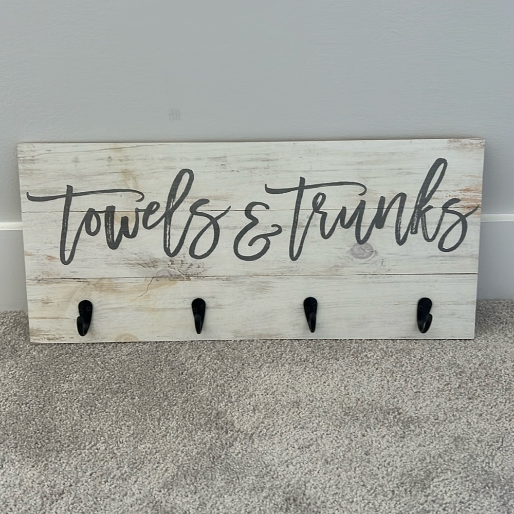 Wooden towels and trunks sign